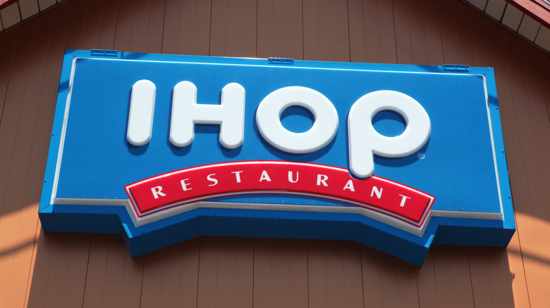 Blue IHOP sign on wooden building