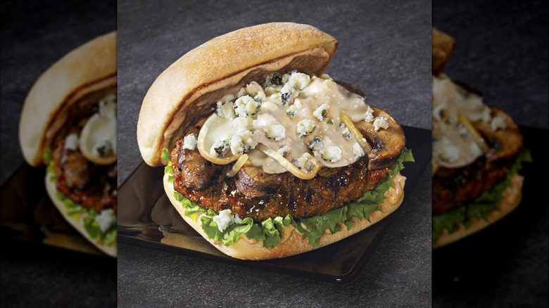 Beef burger with crumbled blue cheese and lettuce
