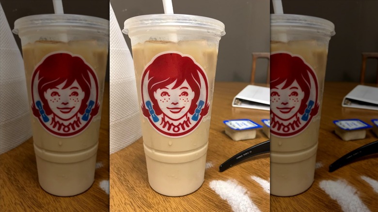 Frosty-ccino in plastic Wendy's cup on wooden table
