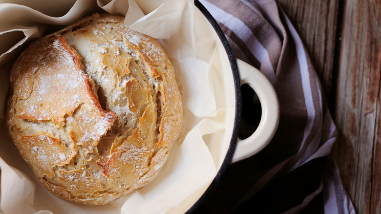 Top view of a no knead bread in dutch oven on a table