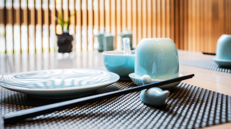 an empty plate with chopsticks on a rest