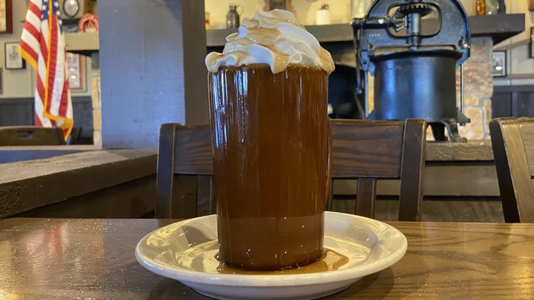 Cracker Barrel Brown Sugar Latte in tall glass on top of white saucer