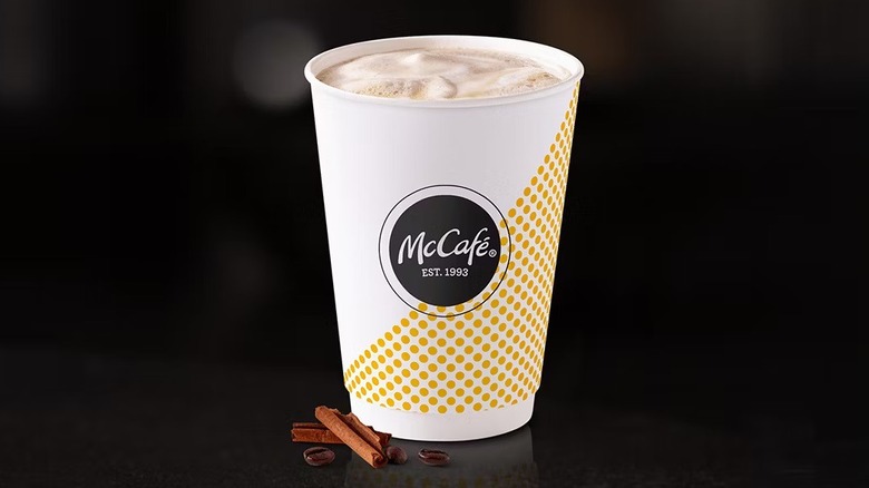 McCafé Pumpkin Spice Latte in paper cup on black surface