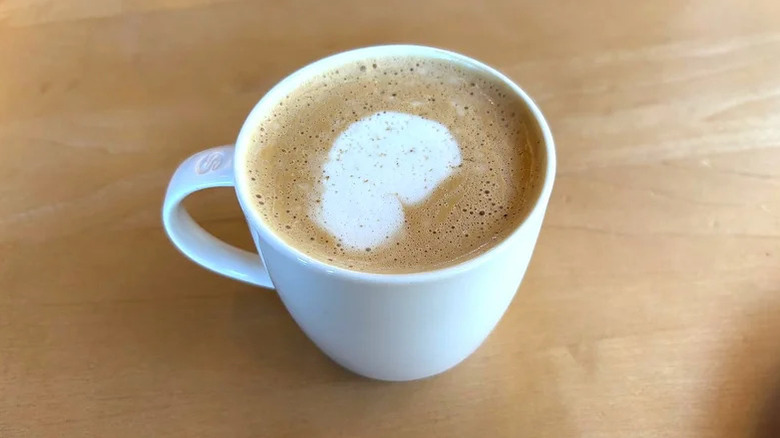 Starbucks Pecan Oatmilk Cortado in white mug on wooden surface