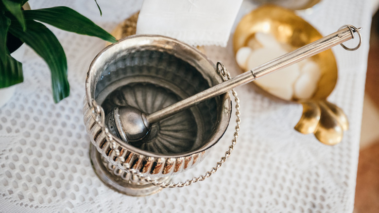 Holy water in silver bucket at a church