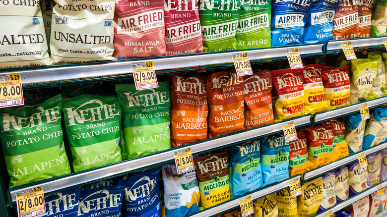 Grocery store shelves with Kettle Brand chips in various flavors