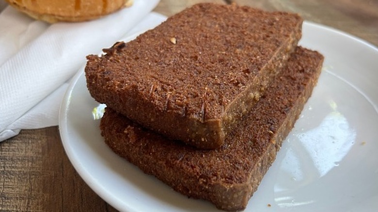 Scrapple slices on white plate.