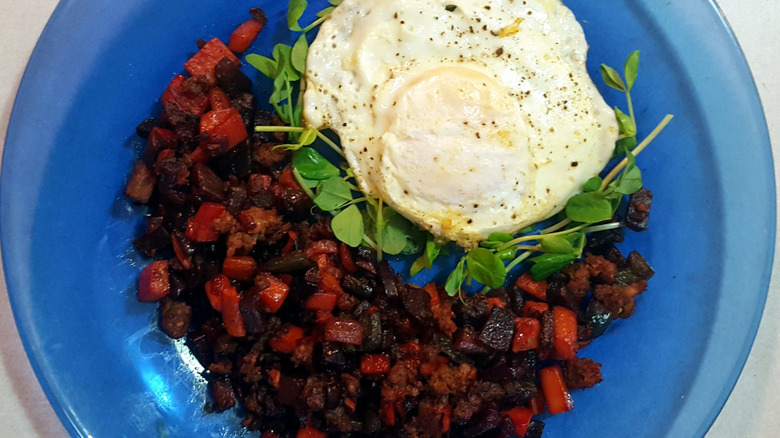 Red flannel hash with poached egg in blue dish