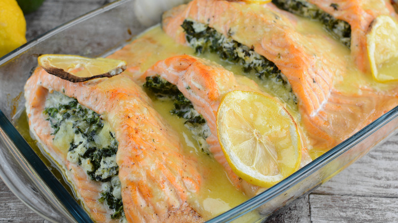 Salmon Stuffed with Spinach and Cheese with lemon in clear dish