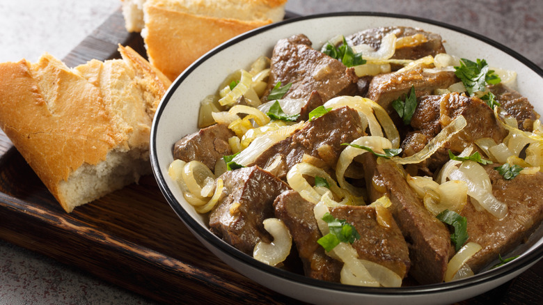 bowl of fried liver with onions served with bread