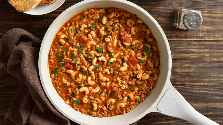 American goulash with macaroni and ground beef in large pan