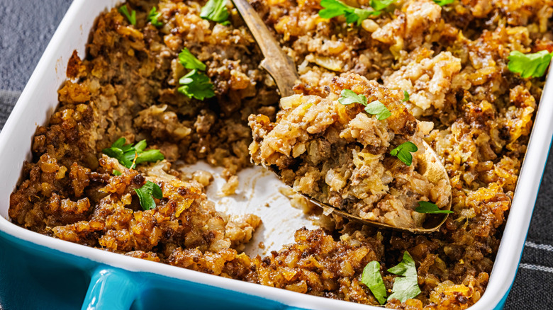 Ground beef casserole in baking dish with spoon