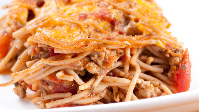 Portion of cheesy spaghetti and ground beef casserole on plate