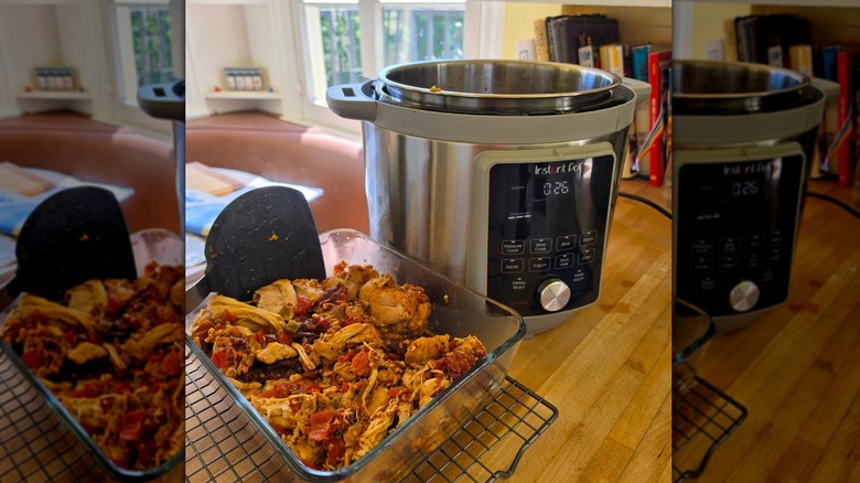 Open Instant Pot next to glass container of food