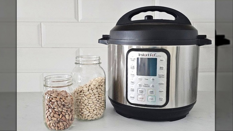 Instant Pot next to two jars of beans on countertop