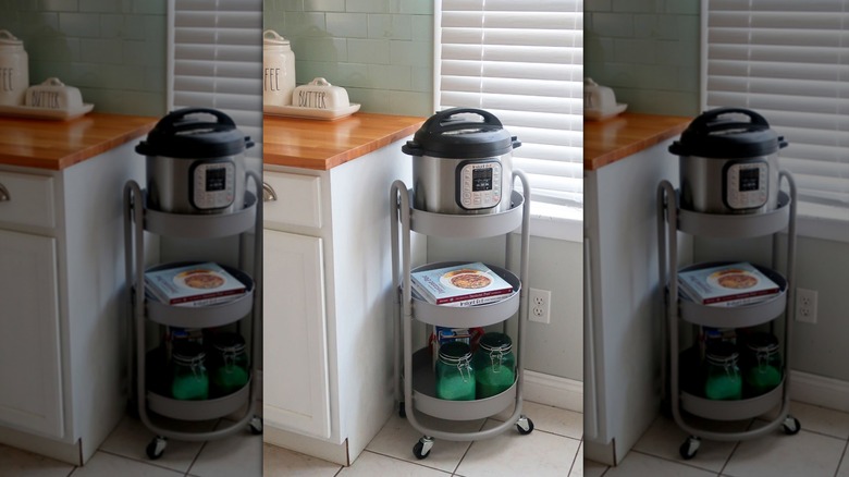 Small shelving unit holding Instant Pot