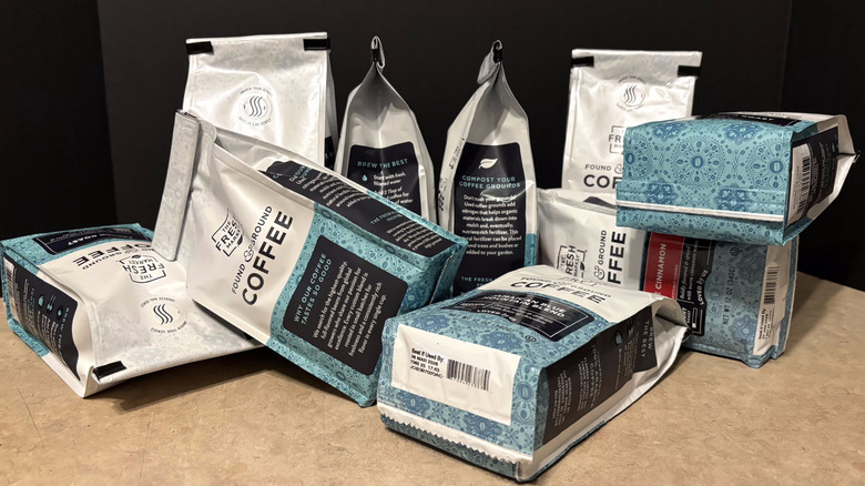 A variety of The Fresh Market coffee in bags on black background