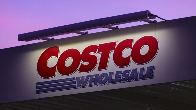 Costco Wholesale sign against purple sky
