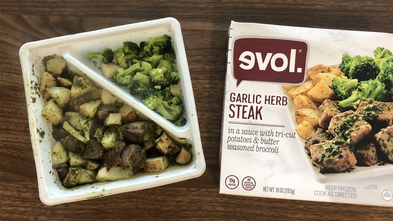 Evol garlic herb steak frozen dinner in tray.