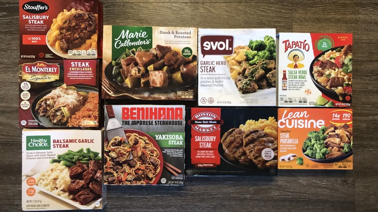 9 different frozen steak dinners laid out side by side.