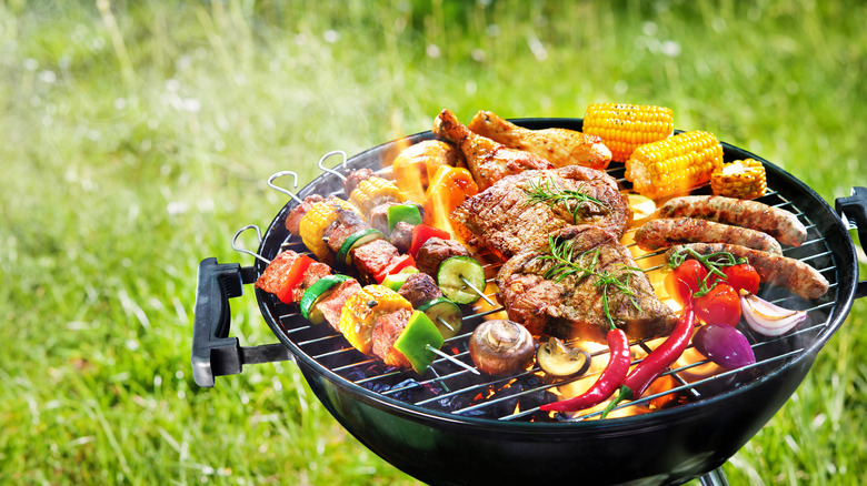 Grill covered with meats and vegetables 