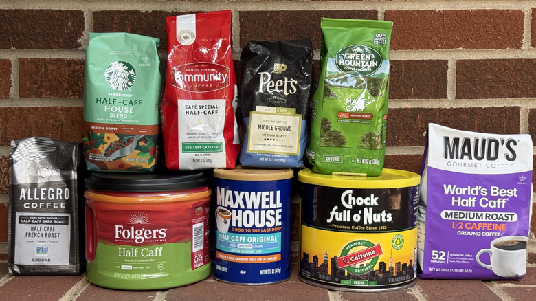 9 half-caff ground coffees from different brands, lined up against brick wall