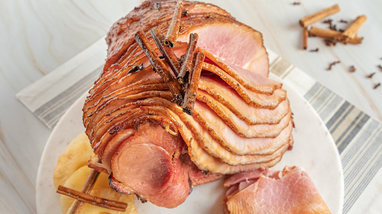 Sliced baked spiral ham on plate