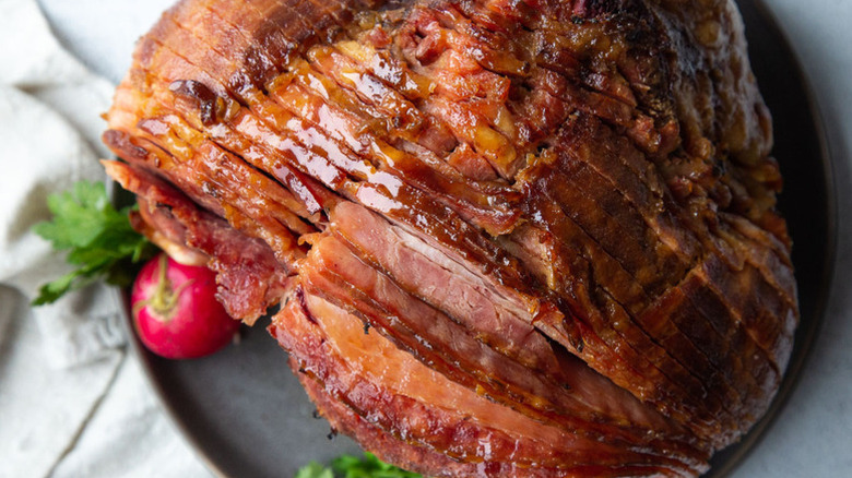 Sliced honey-glazed ham on plate