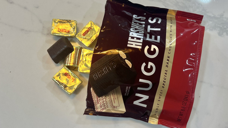 Hershey's Nuggets Special Dark Chocolate with Almonds coming out of bag.