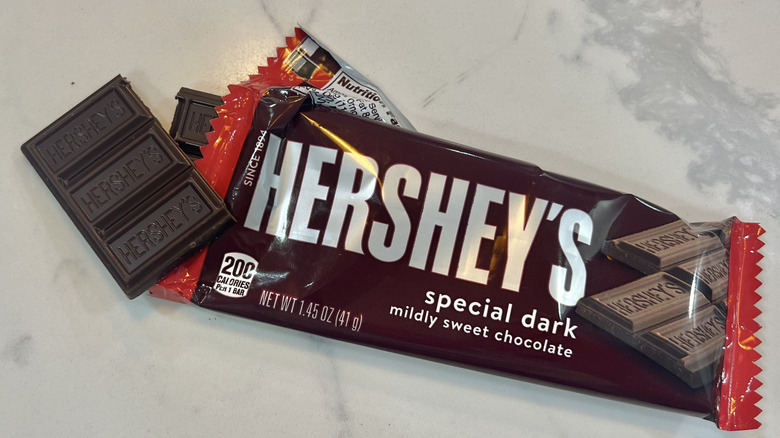 Hershey's Special Dark Chocolate Bar coming out of wrapper.