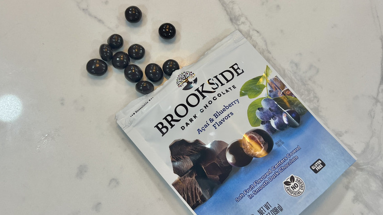 Brookside Açaí & Blueberry chocolate balls coming out of bag.