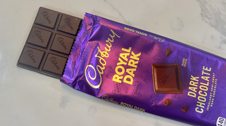 Cadbury Royal Dark chocolate bar coming out of wrapper.