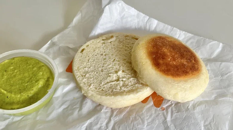 Sliced English muffin with avo spread