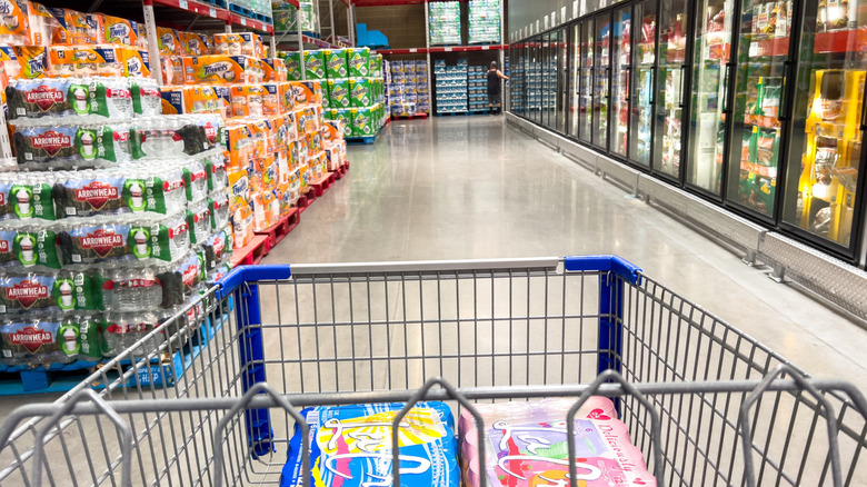 Shopping cart being pushed down aisle of Sam's Club