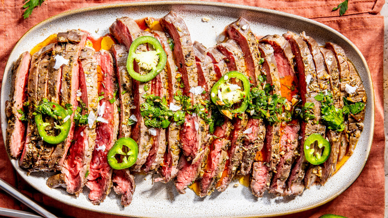 miami churrasco with chimichurri sauce and jalapeno served on a white plate