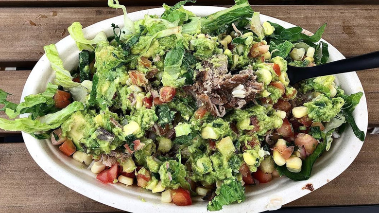 Chipotle carnitas bowl with plastic spoon