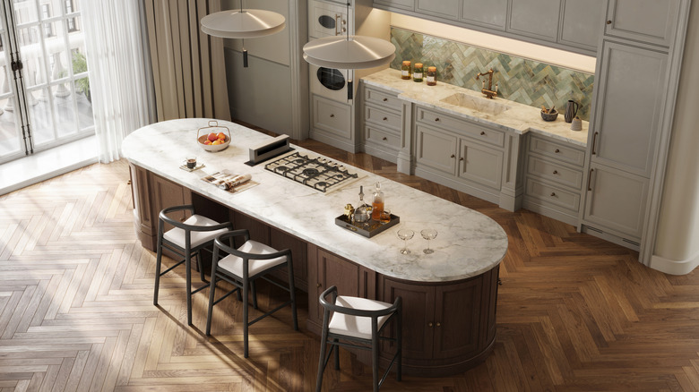 overhead view of kitchen with dark wood island and lighter wood floor