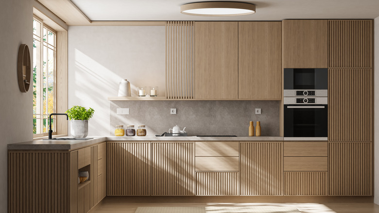 kitchen with wood cabinets matching floor and trim