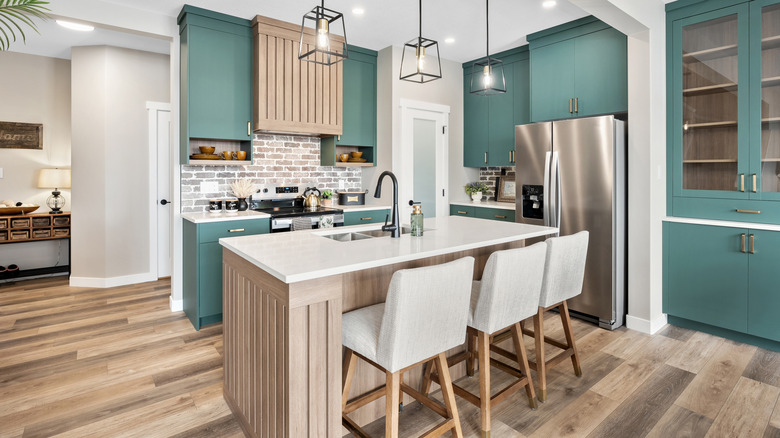 green kitchen with wood accents and wood floor
