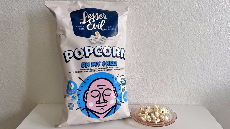 Package of Oh Em Ghee! with popcorn on a plate