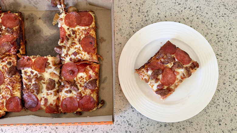 One slice of Detroit-Style Deep Dish 3-Meat Treat on a plate