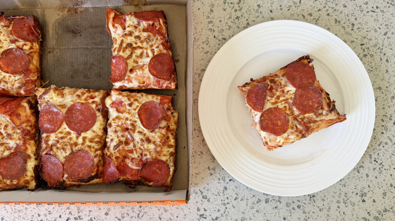 A large slice of Detroit-Style Deep Dish Pepperoni on a plate