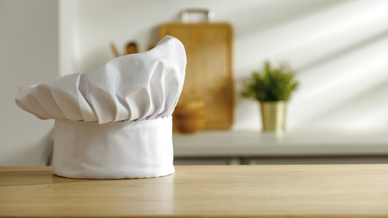 White chef hat sitting on wooden table
