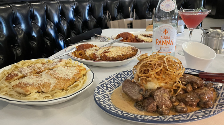 Assortment of Maggiano's dishes on table with drinks