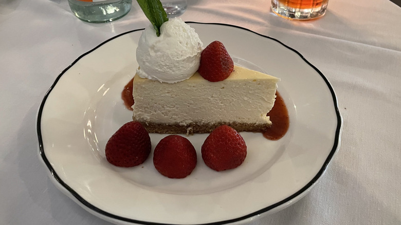Slice of cheesecake with strawberries and whipped cream