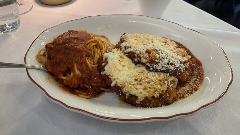 Chicken parmesan with spaghetti and marinara sauce on a plate