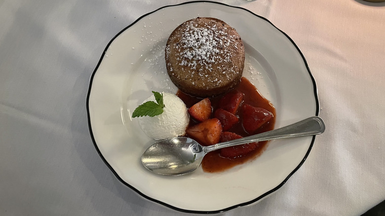 Gigi's Butter cake with strawberry sauce and cream on a plate