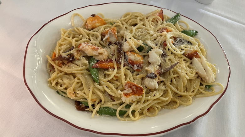 Carbonara pasta with lobster, sugar snap peas, and sliced bacon