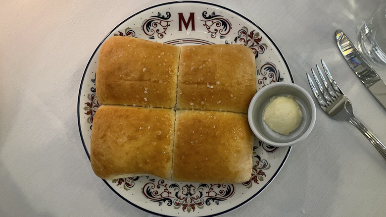 Dinner rolls on plate with butter