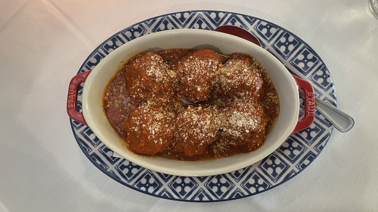Dish of Italian meatballs with freshly grated parmesan